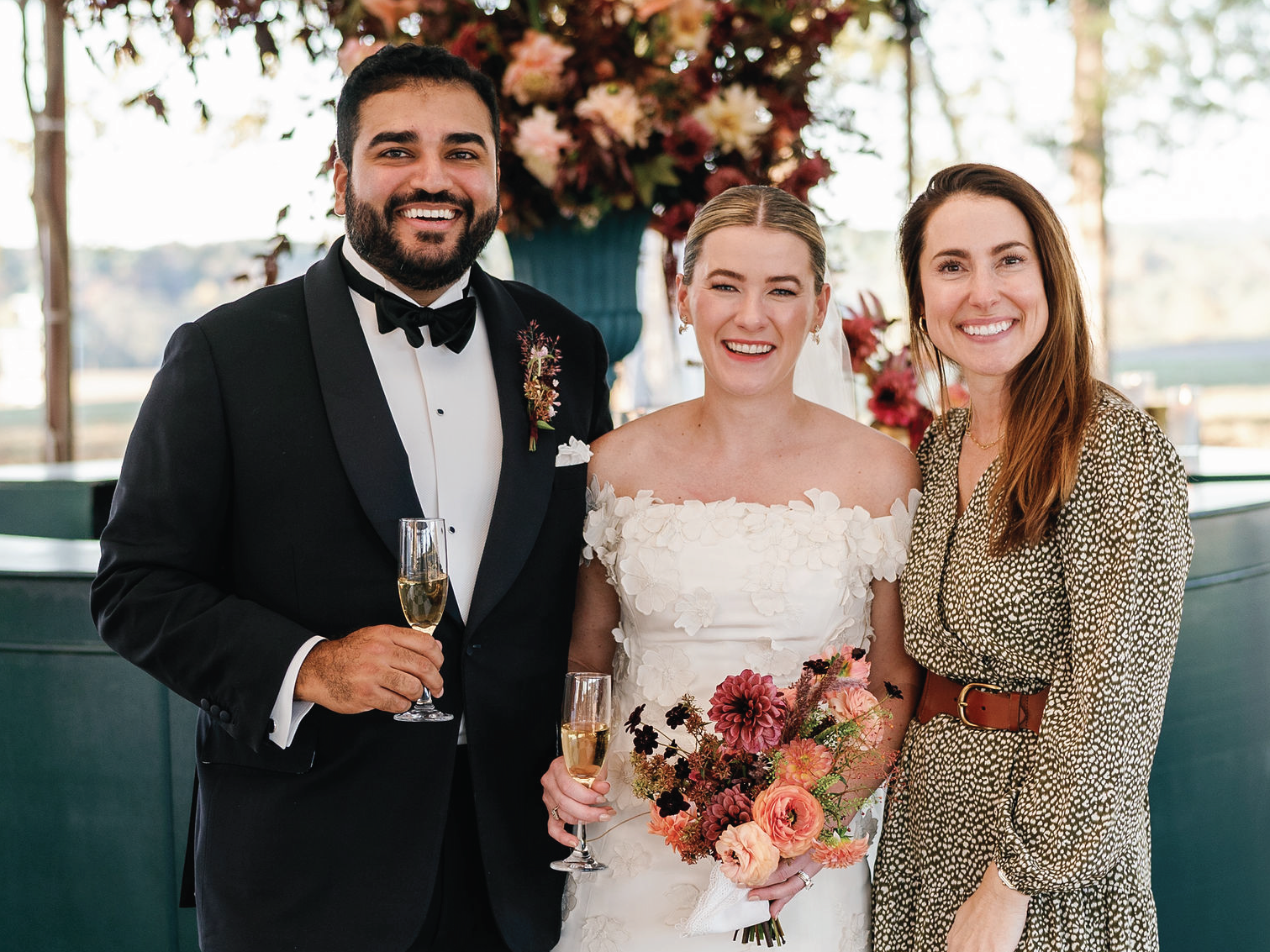 Courtney Drake with happy couple on their wedding day