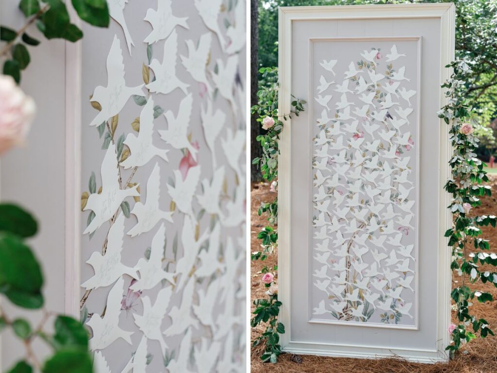 Freestanding escort display with floral design and bird-shaped escort cards