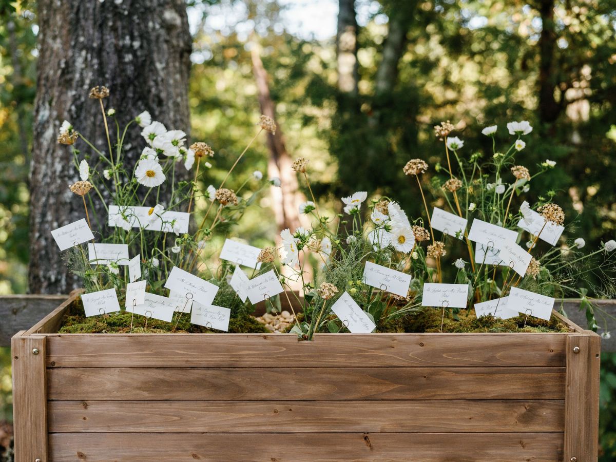 Natural wildflowers and escort display cards inside a garden planter